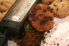 chocolate chip cookies on a plate with a grater