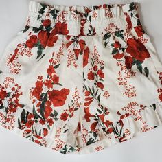 Floral Lined, High Waisted Pinup Style Shorts. 15" Elastic Waist 16" Length 3" Inseam 98% Polyester 2% Viscose Red Floral Print Beach Shorts, White Floral Print Summer Shorts, Red Floral Print Summer Bottoms, Summer Floral Print Red Bottoms, White Floral Print Shorts, Red Floral Print Short Length Bottoms, Red Summer Shorts With Elastic Waistband, Red Elastic Waistband Shorts For Summer, Red Shorts With Elastic Waistband For Vacation