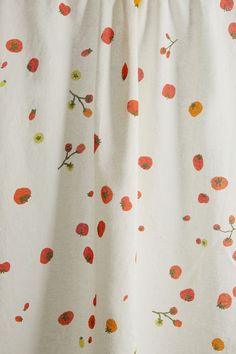 a white curtain with red flowers on it