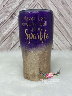 a purple and gold glitter tumbler with the words never let anyone dull sparkle