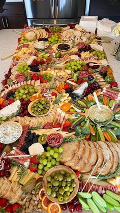 a long table filled with lots of different types of food on top of each other