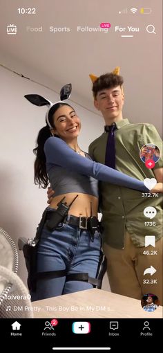 a man and woman are posing for a selfie in front of a mirror with an arrow on it