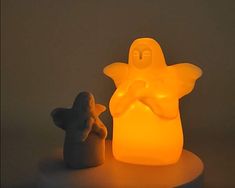 a small figurine is next to a glowing light that looks like a ghost