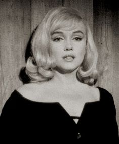 a black and white photo of a woman with blonde hair