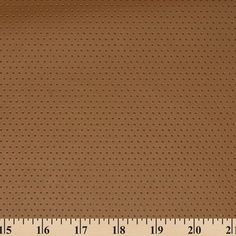 a ruler is next to a brown fabric