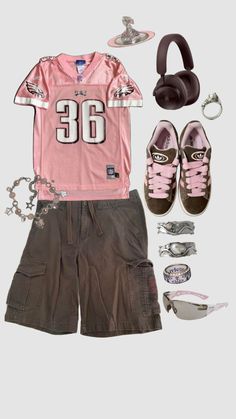 a pink shirt, shorts and headphones are arranged in the shape of a football jersey