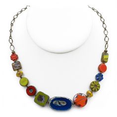 "This  colorful necklace is casual and fun.  It is composed of various size, shape, and color Czech glass beads, alternated with antique brass round beads and attached to an antique brass chain.  All components are antique brass including the adjustable lobster clasp.  The necklace ranges 18 1/2\" - 20 1/2\" in length, and 5/8\" wide at the widest point." Multicolor Round Bead Brass Necklace, Multicolor Round Beads Brass Necklace, Multicolor Brass Necklace With Round Beads, Bead Chain Necklace, Colorful Necklace, Bead Chain, Colourful Necklace, Brass Chain, Czech Glass Beads