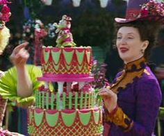 two women standing next to each other in front of a multi - tiered cake