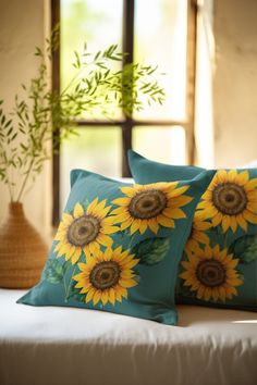 two sunflowers are on the pillows in front of a window