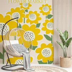 a yellow flower market poster on the wall next to a chair and potted plant