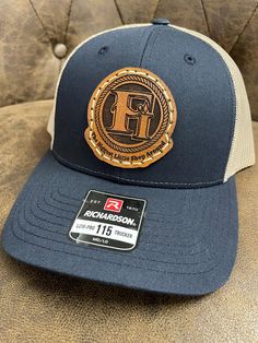 100% customized leather patch hats. We can put just about anything you want on them. All of our leather patches are hand drawn, some are tooled (according to preference) painted, and stitched onto our Richardson 112 or 115 (depending on the color).  Any questions on design/logo or hat colors you can message us prior to ordering. We can do company hats for your business also with bulk pricing.  Our turn around time is 2 weeks. When we get to your order we do send a draft for approval before continuing.  Each patch is glued and hand sewn onto the hat. Leather Patch Cap - Gift, Leather Patch Cap As A Gift, Leather Patch Cap As Gift, Leather Patch Cap Hat Gift, Custom Flat Brim Hats With Leather Patch, Custom Hat With Leather Patch And Flat Bill, Custom Flat Bill Hat With Leather Patch, Custom Trucker Hat With Leather Patch Snapback, Custom Trucker Hat With Leather Patch