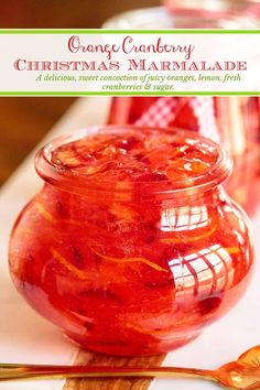 an orange cranberry christmas marmalade in a jar with a spoon next to it