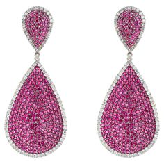 Discover the epitome of elegance with our exquisite 8.71 Carat Diamond and Ruby Fashion Earrings, a testament to meticulous craftsmanship and timeless allure. Each pair is a harmonious blend of sophistication and opulence, designed to captivate discerning tastes and elevate any ensemble to new heights of glamour. Crafted with precision, these earrings feature a stunning arrangement of brilliant-cut diamonds totaling 6.21 carats, meticulously set to maximize brilliance and sparkle with every move Luxury Pink Earrings With Brilliant Cut, Luxury Pear-shaped Bridal Earrings For Formal Occasions, Elegant Pink Diamond Cut Earrings, Luxury Pear-shaped Earrings For Formal Events, Luxury Pear-shaped Earrings For Formal Occasions, Luxury Pink Diamond Earrings, Luxury Platinum Teardrop Diamond Earrings, Luxury Pave Setting Earrings For Formal Events, Luxury Pave Set Earrings For Formal Occasions