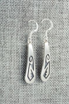 These sterling silver earrings were made by Hopi silversmith Augustine Mowa. The back is stamped sterling.Length: 1 5/8"Width: 1/4"Free shipping on all orders! We ship with USPS and always include tracking. All orders ship within a day of payment.Returns are accepted up to 30 days after you receive your order. Just send us a message. Our shop offers cash back or store credit. The item must be returned in new condition. Engraved Sterling Silver Drop Earrings, Silver Southwestern Style Earrings For Gifting, Silver Southwestern Earrings For Gift, Engraved Teardrop Sterling Silver Earrings, Silver Southwestern Style Earrings For Gift, Southwestern Silver Earrings For Gifts, Classic Engraved Sterling Silver Earrings, Silver Engraved Teardrop Earrings, Silver Engraved Symbolic Earrings