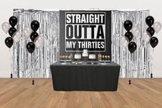 a table with black and white balloons, cake and desserts on it in front of a backdrop that says straight out my thirties