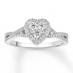 a heart shaped diamond engagement ring on a white background