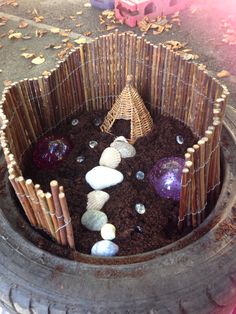 an old tire is filled with rocks and gravel to create a garden in the shape of a tree stump