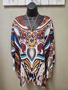 Great top for the fall season vibrant colors in a Geometric design. Very soft to the touch. Great with a pair of dress pants or denim. One size fits small to 2X Viscose, Polyester Hand Wash, Hang Dry Multicolor Print V-neck Top For Fall, Trendy Oversized Multicolor Blouse, Chic Oversized Multicolor Blouse, Oversized Multicolor Blouse For Fall, Oversized Multicolor Graphic Print Blouse, Oversized Printed Multicolor Blouse, Oversized Printed Multicolor Tops, Trendy Multicolor Tops For Fall, Chic Multicolor Blouse For Fall