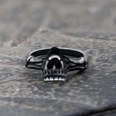 This wide ring adopts a retro style, which makes this skull look more hideous and... Gothic Black Rings With Skull Print, Halloween Black Skull Ring, Black Skull Ring For Halloween, Black Metal Skull Ring For Streetwear, Halloween Black Stainless Steel Ring, Black Stainless Steel Rings For Halloween, Vintage Black Metal Skull Ring, Punk Style Black Skull Rings, Black Skull Rings Punk Style