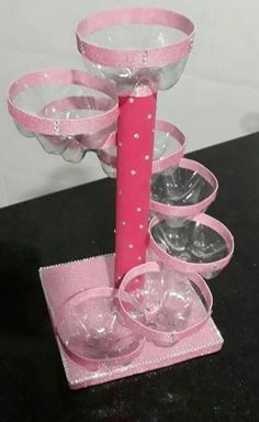 there is a pink candle holder made out of wine glasses