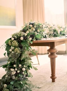 a table with flowers and greenery on it