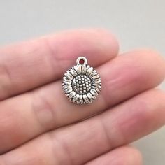 Sunflower charms, daisy flower pendant beads in antique silver finish.Shape: lovely solid sunflower or daisy disc (single sided)Quantity: 30pcs in one packageSize: approx. 15X18mm or 9/16"X11/16"Color: antique silverAntique bronze version: https://www.etsy.com/ca/shop/beadtoyou?search_query=CM1515BCheck out my other flower charms: https://www.etsy.com/ca/shop/beadtoyou?search_query=flowerAll my findings are lead free, nickle free/nickle safe. Meaningful Nickel-free Pendant Charm Necklace, Silver Round Pendant Spiritual Charm, Inspirational Nickel-free Silver Charm Necklaces, Silver Nickel-free Charm Necklace For Friendship, Inspirational Silver Nickel-free Charm Necklaces, Silver Round Charm Necklace For Friendship, Silver Charm Necklace With Round Pendant For Friendship, Metal Round Charms For Gifts, Round Metal Charms For Gifts