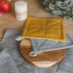 a wooden cutting board topped with a yellow cloth