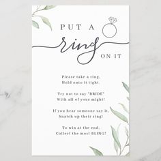 a white card with the words put a ring on it and green leaves around it