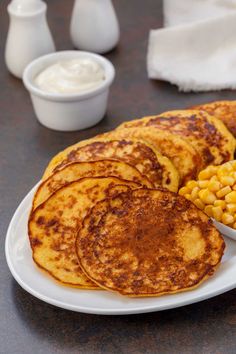 some pancakes and corn on a plate