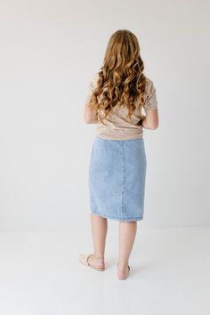 Create an instant feminine look wearing the 'Cassidy' Skirt! Featuring a button-front design and tie waist, this denim midi skirt makes a perfect choice for both casual or formal occasions. The soft, lightweight denim in a regular fit offers comfort, while the pull-on style allows easy wear. Pair the 'Cassidy' with a black tee and sneakers for a fun day in the city or running errands in town! 75% Cotton 25% Polyester Hand Wash Cold Do Not Bleach Hang to Dry Low Iron if Needed Model Height 5'7" | Summer Workwear Denim Skirt With Button Closure, Spring Medium Wash Knee-length Skirt, Chic Midi Denim Skirt With Pockets, Trendy Relaxed Knee-length Denim Skirt, Spring Knee-length Lined Denim Skirt, Casual Midi Length Pencil Skirt For Day Out, Trendy Knee-length Relaxed Denim Skirt, Medium Wash Relaxed Knee-length Skirt, Casual Pencil Skirt With Button Closure