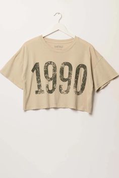 1990 Cropped Vintage-Print Graphic Tee | ShopPromesa Vintage Cropped T-shirt With Graphic Print For Summer, Retro Cropped T-shirt With Text Print For Summer, Vintage Text Print T-shirt For Spring, Acid Wash Cropped Crew Neck T-shirt For Summer, Acid Wash Cropped T-shirt For Spring, Acid Wash Casual Cropped T-shirt For Spring, Casual Acid Wash Cropped T-shirt For Spring, Vintage Graphic Print Cropped T-shirt For Streetwear, Vintage Slogan Tops For Spring