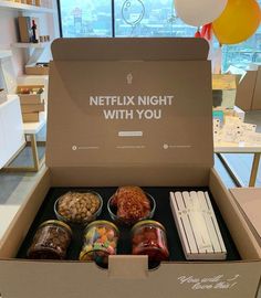 a box filled with different types of snacks and condiments on top of a table