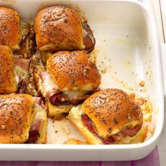 a white casserole dish filled with ham and cheese sliders