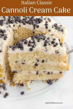 a cake with white frosting and chocolate chips on top is cut in half to show the inside