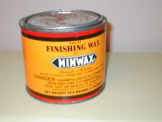 a can of minwax paste sitting on top of a white table next to a wall