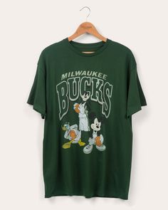 Unisex Bucks Disney Team Mickey Squad Tee | Junk Food Clothing Sporty Fan Merchandise T-shirt With Front Print, Sporty T-shirt With Front Print For Fans, Throwback T-shirt With Team Logo, College Throwback T-shirt With Team Logo, Green Crew Neck Retro Top, Throwback T-shirt For College Sports Season, Throwback College T-shirt For Sports Season, Throwback Green Tops For College, Retro Cotton T-shirt With Team Logo