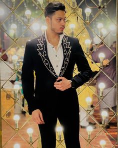 Make an edgy statement with our designer BLACK EMBROIDERED SUIT designed thoughtfully for the modern Indian man. A fusion staple fit for every occasion, adds the right amount of cultural twist to the western silhouette. Color: Black  Garment Type: tuxedo Neck: Mandarin Collar Fabric: Micro Velvet Embroidery: Zari work with sequin embroidery The Product Price is inclusive of: 1 tuxedo, 1 shirt, 1 vest coat and 1 Trouser Style Bottom Product color may slightly vary due to photographic lighting sou Black Designer Tuxedo, Wedding Suits Men Black, Suit For Men Wedding, Designer Tuxedo, Western Silhouette, Indian Jackets, Black Coat Men, Jodhpuri Suit, Stylish Mens Suits