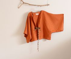 "This is a made to order listing for kimono wide sleeve jacket, please choose colors for jacket and flowers at check out. Thanks! material: eco linen design: wide kimono sleeve linen jacket in rust linen ginger linen bias strap reinforced on neckline and ginger roses and strings on the jacket center for closure. wide 60\" room ( if you prefer less wide, please mention at check out) length 26\" room a loose fit jacket to fit all sizes This listing is priced for the jacket only. if you are interes Kimono Sleeve Top, Diy Vetement, Linen Jackets, Womens Jackets, Linen Jacket, Sleeve Jacket, Kimono Jacket, Kimono Sleeve, Linen Top