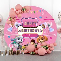 a pink birthday card with balloons, candles and stuffed animals in front of the sign that says happy birthday