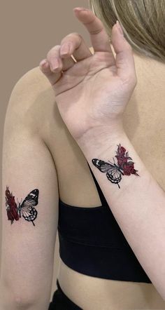 a woman's arm with two butterfly tattoos on her left wrist and the other hand