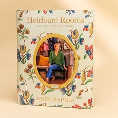 a book with an image of a woman sitting on a chair in front of flowers