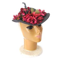 "This 1940s feminine hat has a a semi deep fitted crown with brim at the front that narrows as it wraps around the side. This is a charming round crown shell cap or bonnet, decorated with a striking arrangement of millinery flowers on the front brim. The color of the hat is a mid-value gray/green. The flower are hot pink, fuchsia and green. The spirals are wrapped in the same fabric that covers the hat. There is a white translucent cube hat pin in the back. This hat is in excellent condition. Si Fitted Wide Brim Hat For Vintage Events, Victorian Short Brim Hat For Vintage Events, Victorian Fitted Brimmed Costume Hats, Fitted Cloche Hat For Garden Party, Fitted Vintage Hat With Curved Brim, Fitted Fedora For Vintage Events, Fitted Vintage Brimmed Boater Hat, Victorian Fitted Hat With Curved Brim, Victorian Cloche Hat For Kentucky Derby