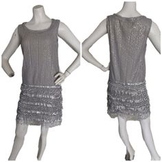 Be The Belle Of The Ball In This Stunning Silver Flapper Dress From Max Studio Specialty Products. This Knee-Length Sheath Dress Features A Beautiful Batik Pattern, Boat Neck Neckline, And Sleeveless Design. The Dress Is Made From A Luxurious Microfiber Fabric That Contains Polyester, Spandex, And Polyester Blend Materials. The Dress Features Eye-Catching Accents Such As Fringes, Beads, And Sequins That Add To Its Overall Glamour. The Dress Is Perfect For Any Formal Occasion Such As Weddings, Pa Sleeveless Sequined Flapper Dress For Summer, Fitted Sleeveless Flapper Dress For Summer, Sleeveless Sequined Summer Flapper Dress, Spring Sleeveless Flapper Dress, Elegant Sleeveless Spring Flapper Dress, Sequin Sleeveless Fitted Flapper Dress, Sleeveless Sequined Fitted Flapper Dress, Fitted Sleeveless Sequin Flapper Dress, Silver Flapper Dress