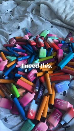 a pile of colorful crayons sitting on top of a bed