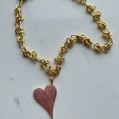 This charming Carrie Love Knot Heart Necklace in gold and pink is perfect for adding a little love to your everyday outfit. With its unique knot design, this necklace is a subtle way to express your affection. Wear it solo or layer it with other pieces for a stylish look. Shop more Necklaces Available in more colors Gold/Pink Barb Wire Chain Slanted pave crystal heart charm 16" around Valentine's Day Gold Chain Necklace With Heart Pendant, Rose Gold Heart-shaped Chain Necklace, Valentine's Day Gold Heart Pendant Chain Necklace, Pink Pendant Charm Necklace, Pink Pendant Chain Necklace Gift, Pink Pendant Chain Necklace As Gift, Valentine's Day Heart Necklaces With Gold Chain, Valentine's Day Heart Necklace With Gold Chain, Valentine's Day Gold Chain Heart Necklace