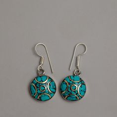 Silver Turquoise Earrings Set About The Earing: The Silver Turquoise Earrings Set is a remarkable example of artisanal craftsmanship, delicately handcrafted on white metal and finished with a gleaming silver coating. Each earring includes a stunning turquoise stone that has been carefully chosen to highlight its unique hue and natural beauty. The stunning design and excellent craftsmanship of these earrings make them ideal for every event, giving a touch of elegance and glamour to any look. Thes Nickel Free Round Fusion Earrings, Nickel-free Round Fusion Earrings, Round Pierced Fusion Jewelry, Handmade Turquoise Fusion Earrings, Turquoise Hallmarked Earrings For Gift, Traditional Sterling Silver Earrings With Natural Stones, Traditional Blue Round Earrings, Nickel-free Round Fusion Jewelry, Traditional Round Natural Stones Jewelry