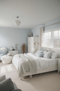 a bedroom with blue walls and white furniture