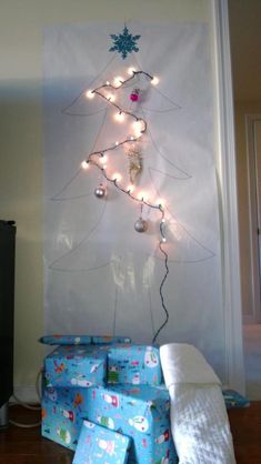 a christmas tree made out of wrapping paper with lights hanging from it's branches