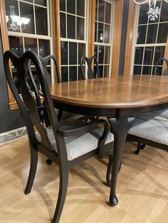 a dining room table and chairs in front of windows with wood flooring on the side