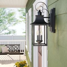 an outdoor light hanging on the side of a house